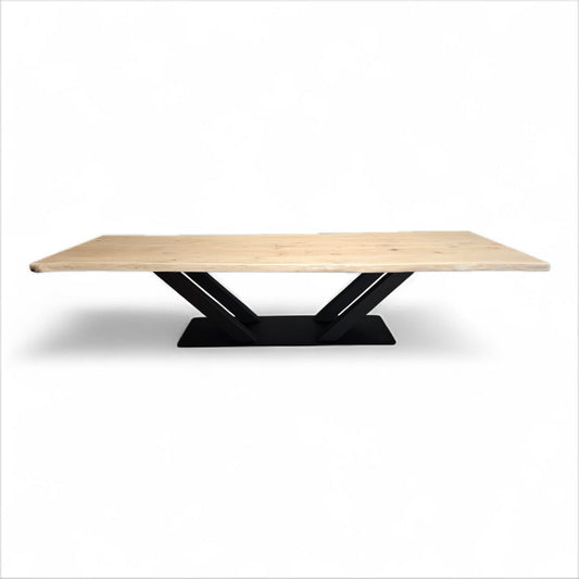 Massiver Esstisch mit naturbelassener Wildeichenplatte und X-förmigem schwarzem Stahlgestell auf Bodenplatte – modernes Industrial Design